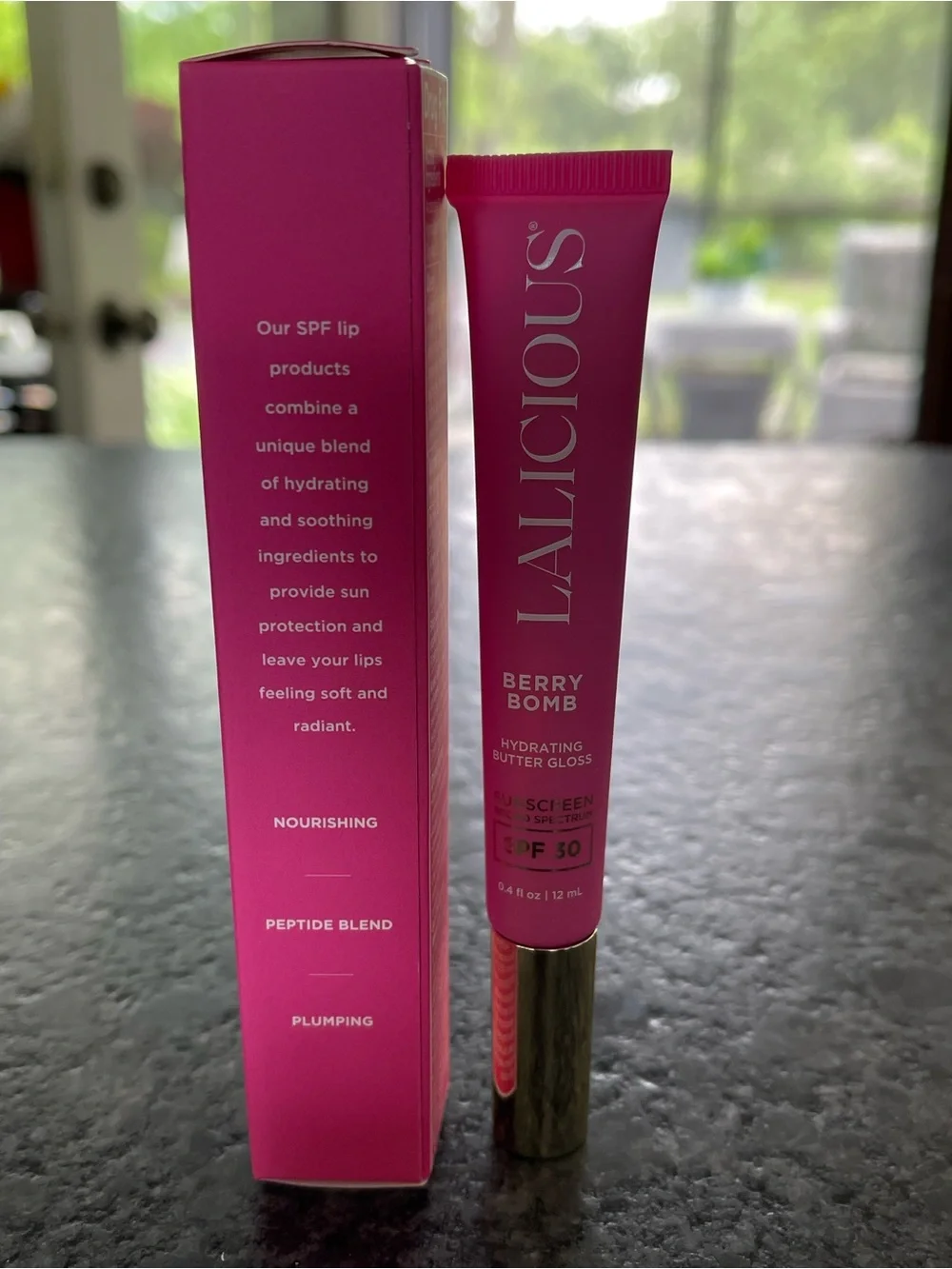 LALICIOUS Hydrating Butter Gloss SPF 30 in Berry Bomb shine shield plump hydrate